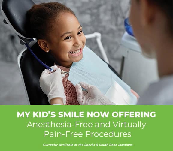 Child smiling at dentist, pain-free dental care offered.